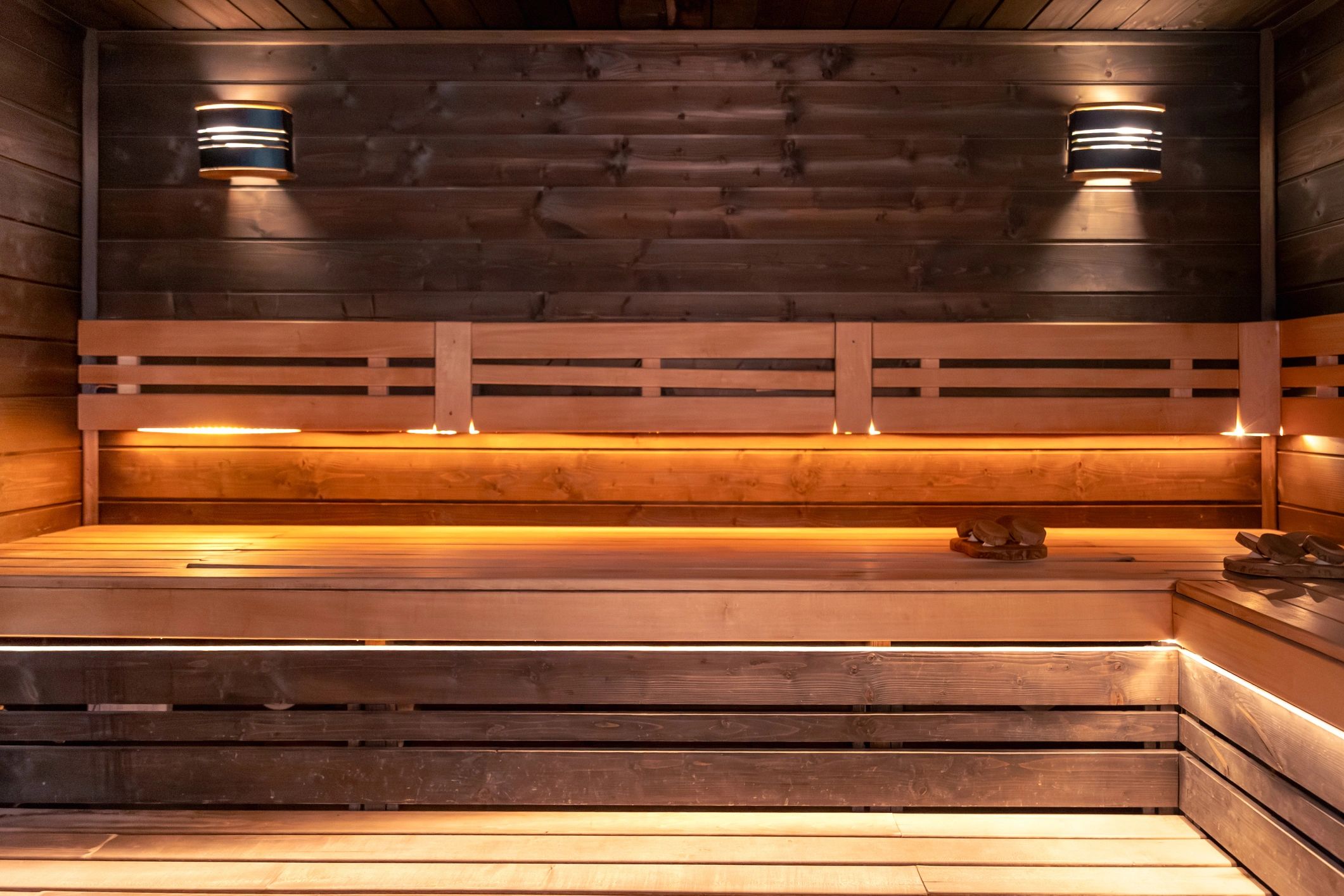 Warm, inviting sauna interior representing restorative wellness therapies